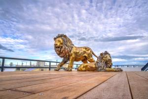 a statue of a lion and a lion laying down at The Address Napier in Napier