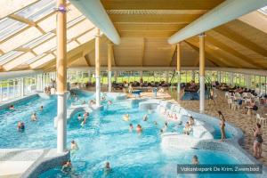 a group of people in a swimming pool at Vakantiepark De Krim Texel in De Cocksdorp