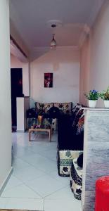 a living room with a couch and a table at The Perfect Tenant For Rent in Agadir