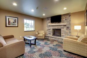 a living room with two couches and a fireplace at Cobblestone Inn & Suites - Schuyler in Schuyler