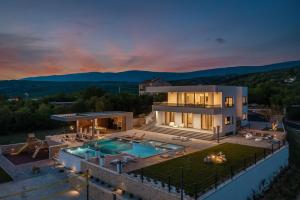 una vista aerea di una casa con piscina di Luxury Villa Arya with 77sqm heated pool, hot-tub, sauna, gym, billiard, playgrounds, 6 bedroom a Bajagić