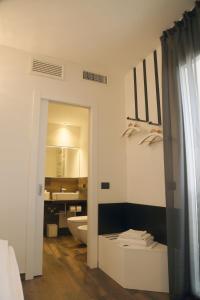 a white bathroom with a toilet and a sink at Ca Bianca in Montiano