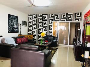 a living room with a couch and a table at Serenity plus in Accra