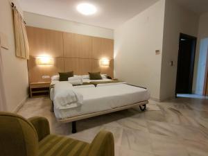A bed or beds in a room at Hotel Boutique Convento Cádiz