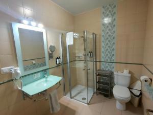 a bathroom with a shower and a sink and a toilet at Hotel Boutique Convento Cádiz in Cádiz
