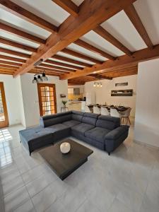 a living room with a couch and a table at gite boutx 10 personnes in Boutx