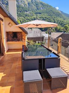 a swimming pool with an umbrella on a patio at gite boutx 10 personnes in Boutx