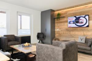 a living room with a couch and a table at AvenidA Style Appartements by Alpin Rentals - incl Summercard in Kaprun