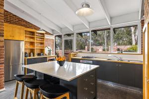 a kitchen with a large kitchen island with bar stools at The Reserve Barossa in Nuriootpa