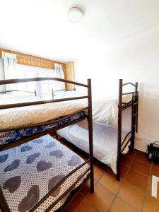 two bunk beds in a room with a tile floor at Maribel ERB Alojamientos in Sierra Nevada