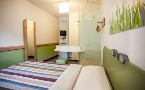 a hospital room with a bed and a sink at Ecomotel Grayston previously known as SUN1 Wynberg in Johannesburg