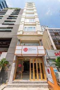 a building with a sign in front of it at Edoya hotel Dong Khoi in Ho Chi Minh City