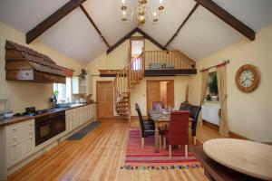 a kitchen and dining room with a table and chairs at La Villa Olli -Natural pool & Hot tub in Bristol