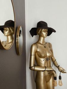 尚貝里的住宿－L'Appart d'Hugo，戴帽子和镜子的女人雕像
