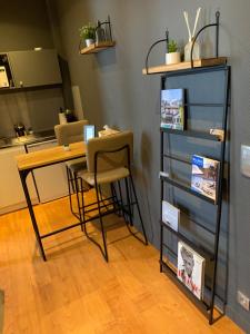 a desk with a chair and a table with a laptop at L'Appart d'Hugo in Chambéry