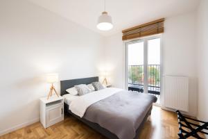 Posteľ alebo postele v izbe v ubytovaní Apartament Lekka