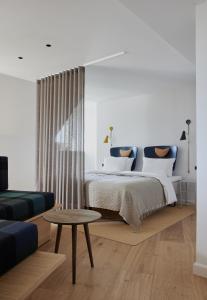 a bedroom with a bed and a couch and a table at Apartments by Brøchner Hotels in Copenhagen