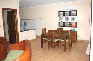 a kitchen and dining room with a table and chairs at Malinamoc Paradise in Dili