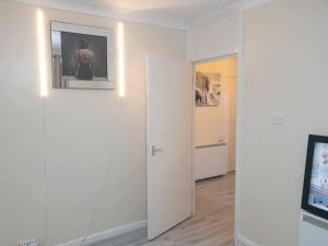 a white room with a door and a picture on the wall at Your Home away from home in Leeds - on the Ring Rd in Leeds