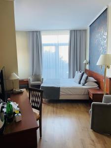 A bed or beds in a room at Thermal Hotel Visegrád