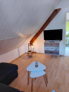 a living room with a couch and a tv at Appartement Boutx 4 PERSONNES in Boutx