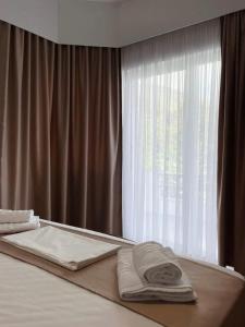 a bed with towels on it with a window at Villa Pargua in Borsh