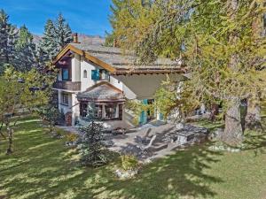 an aerial view of a house with a tree at Chesa Alvan - Surlej in Surlej