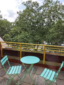 a table and two chairs on a balcony at Tante Emma Sydney in Paderborn