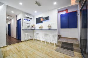 a kitchen with a bar and stools in a room at Meta Hotel in Kuala Lumpur