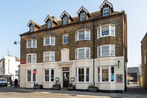 a large brick building on the corner of a street at Top Floor Flat on Harbour Street with sea views in Whitstable