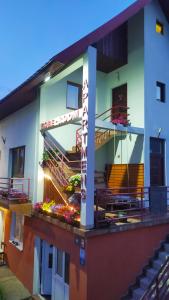 a building with a sign on the side of it at Apartmani Božana Vojinović in Žabljak