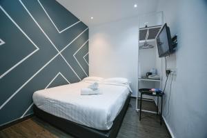 Postel nebo postele na pokoji v ubytování Meta Hotel