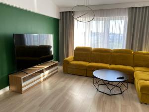 a living room with a couch and a table at Apartament Nidzica Rzemieślnicza 4 in Nidzica
