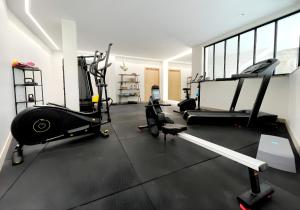 a gym with treadmills and elliptical machines at Lodges Minho in Ponte da Barca