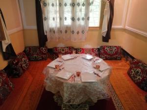 a table in a room with chairs and a window at Assounfou in Ouarzazate