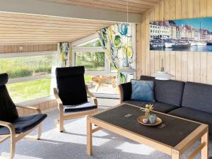 a living room with a couch and two chairs and a table at 6 person holiday home in Jerup in Jerup
