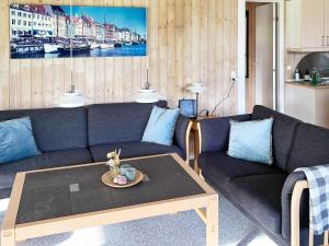 a living room with a couch and a coffee table at 6 person holiday home in Jerup in Jerup