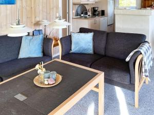 een woonkamer met een bank en een tafel bij 6 person holiday home in Jerup in Jerup