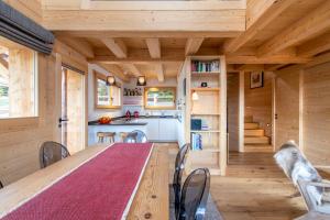 a kitchen and dining room with a long table in a tiny house at Chalet Melilot in Verbier