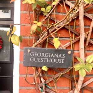 a sign on the side of a brick building at Georgiana's Guesthouse in London