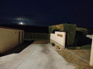 a walkway leading to a fence at night at CASA O QUINTEIRO in Vimianzo