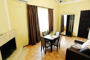 a living room with a table and a couch at Tunti's Apartments in Tbilisi City