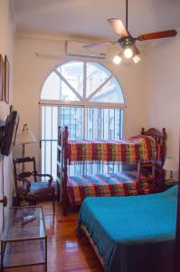 a bedroom with two beds and a large window at My House Buenos Aires in Buenos Aires