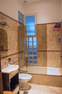 a bathroom with a tub and a sink and a toilet at My House Buenos Aires in Buenos Aires