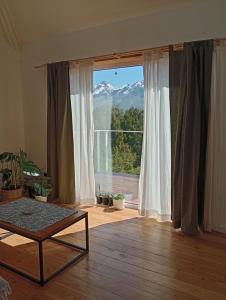 a room with a window with a view of a mountain at Adelina Hue in San Carlos de Bariloche