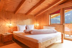 a bedroom with a bed in a wooden house at Ferienhaus Oetztal in Sautens