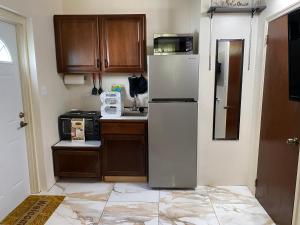 a kitchen with a white refrigerator and wooden cabinets at More Than Beauty Properties in Road Town