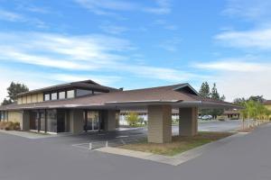 a building with a brown roof on a street at Americas Best Value Inn Vacaville in Vacaville