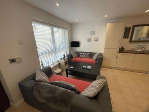 a living room with a couch and a table at Ballycastle, Beachside Apartment in Ballycastle