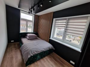 Posteľ alebo postele v izbe v ubytovaní PocztowaResort